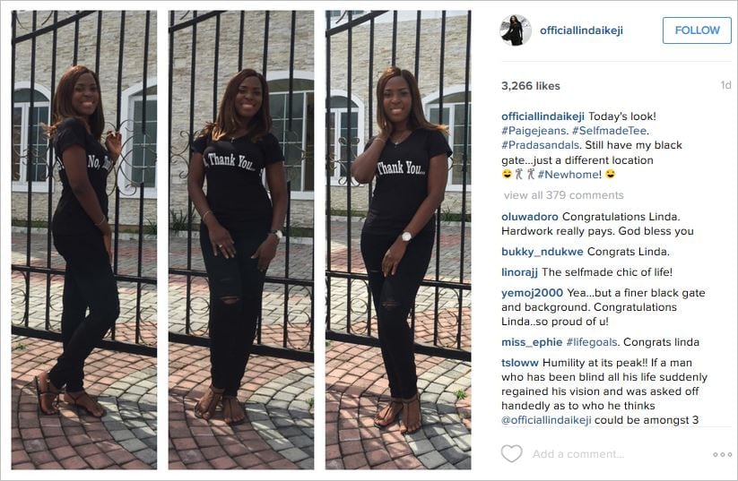 Linda Ikeji standing right at the entrance gate to her newly acquired $2million+ mansion | Constative.com