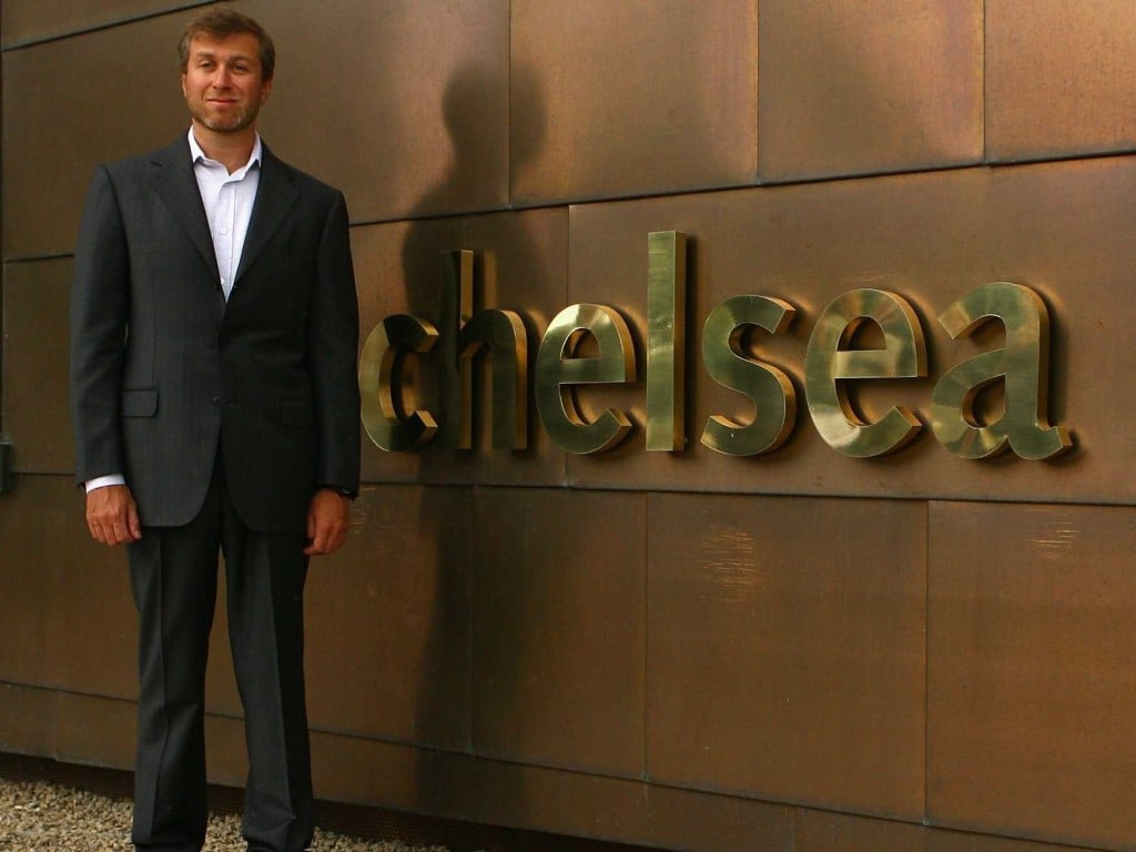 Roman Abramovich standing next to one of his most priced procession, Chelsea emblem. His net worth is $9.1billion | Photo credit: SportsKeeda