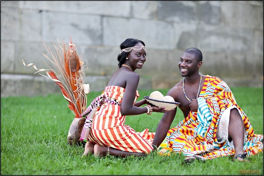 A newly traditionally wedded couple in Ghana having their first meals together | Photo credit: africanfashionwear.it